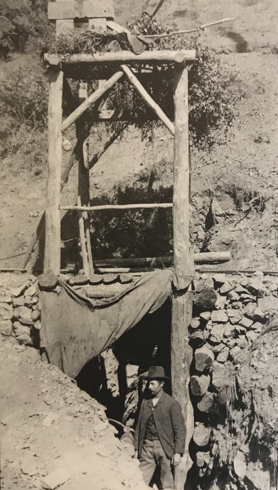 William D. Cruikshank at the timbered shaft of the Last Chance Mine, Los Burros, c. 1889