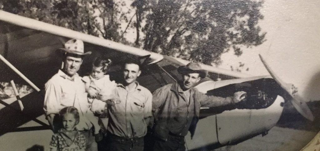 Gordon Plaskett Sr. standing with his airplane