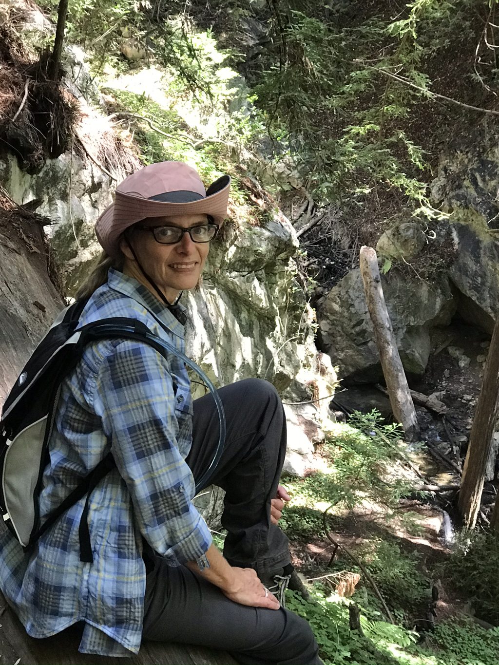 Kim Alderson resting above the boulders of Mill Creek on the hike to the old mill site.